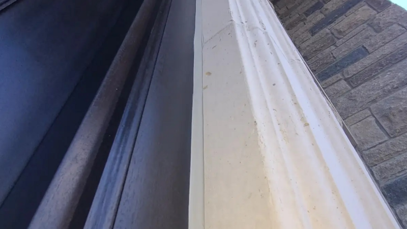 A detailed close-up showcasing the precision caulking work around the door of a luxury home’s grand entrance, highlighting our commitment to flawless craftsmanship and durability.