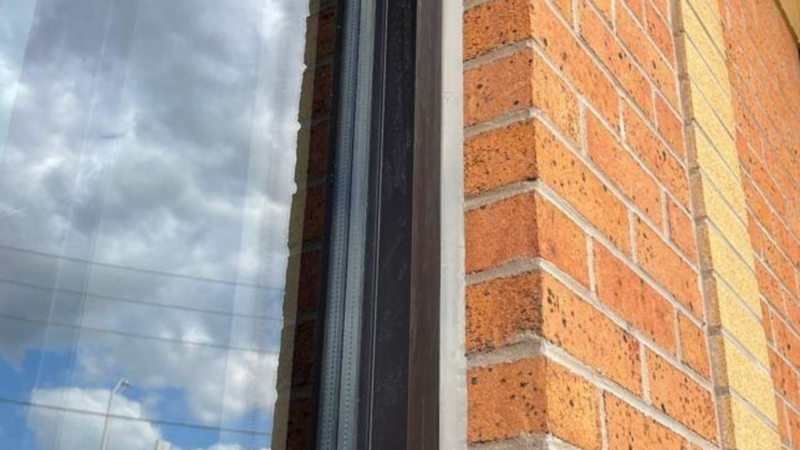 Close-up showcasing precision work on a window at one of over 100 CIBC locations across Ontario, ensuring lasting durability and weather protection.