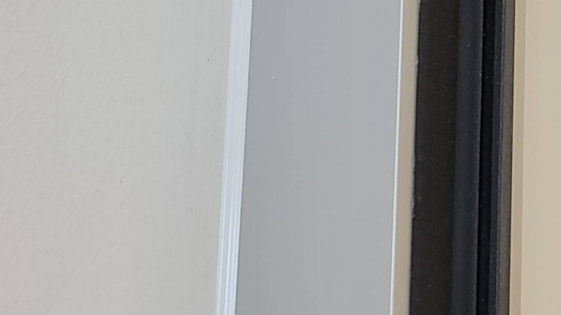 Precise interior caulking applied to the corner between the wall and door, ensuring a clean, seamless finish while preventing drafts and moisture buildup.